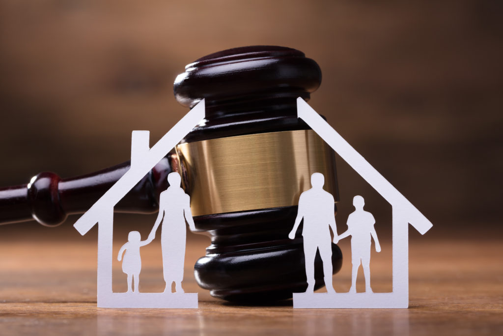 white,family,paper,cut,out,in,front,of,judge,gavel